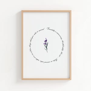 May include: A framed art print featuring a watercolor illustration of a purple flower. The flower is centered within a circular text that reads, "Friendship is unnecessary, like philosophy, like art... It has no survival value."