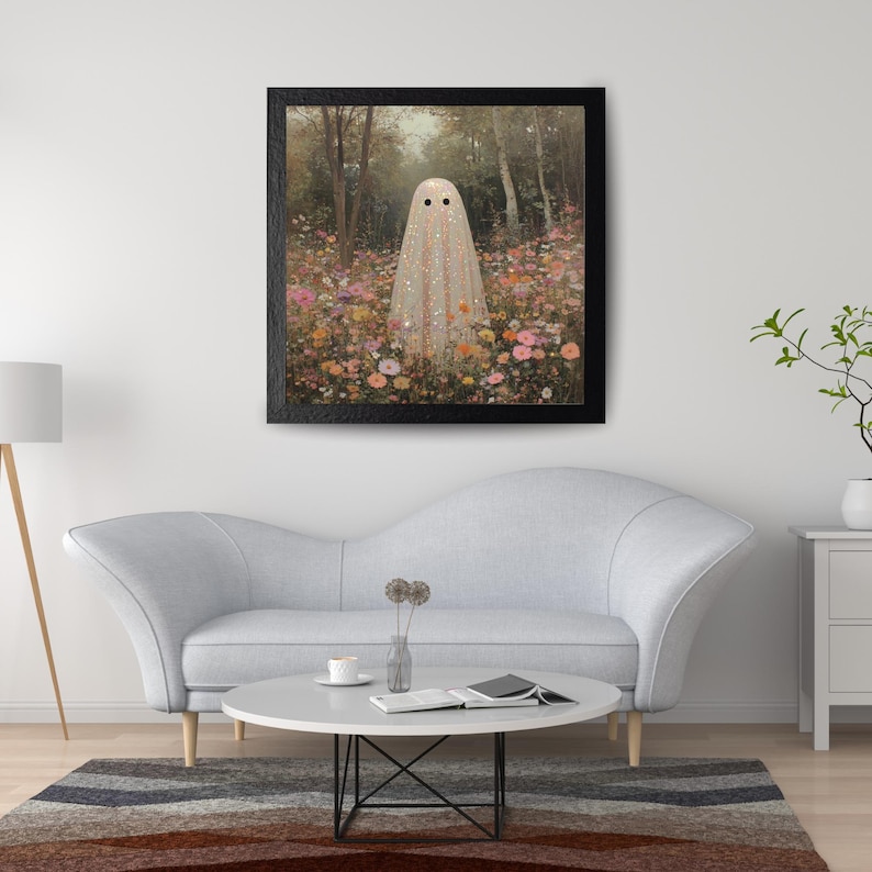 May include: Framed art print featuring a whimsical ghost figure in a field of colorful flowers. The ghost is draped in a shimmering, glittery fabric. The artwork is set against a backdrop of a forest with trees and a soft, dreamy atmosphere.