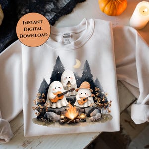 May include: White sweatshirt featuring a watercolor illustration of three cartoon ghosts around a campfire, playing guitars and holding a lantern. The design includes trees, a moon, and the text "INSTANT DIGITAL DOWNLOAD" in a circular orange shape.