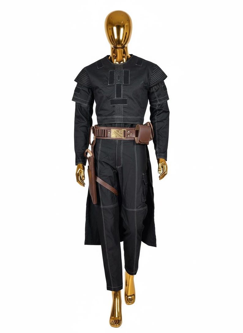 May include: Black costume with white stitching, displayed on a gold mannequin. The outfit includes a long-sleeved top, pants, and a belt with a pouch. A holster and a long coat complete the ensemble. The costume is designed with a futuristic aesthetic.