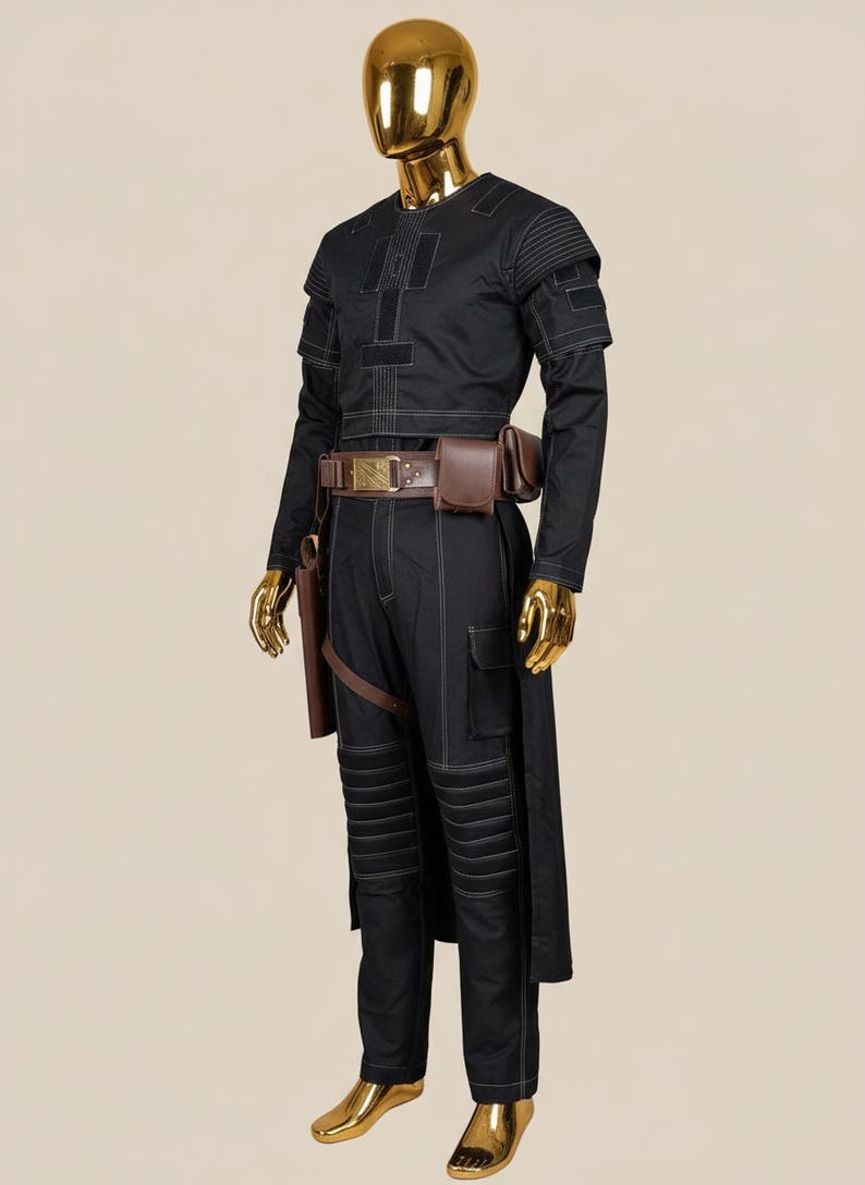 May include: Black costume with white stitching, featuring a long-sleeved top, cargo pants, and a long coat. The outfit includes a brown belt with pouches and a holster. The mannequin has a gold head, hands, and feet.