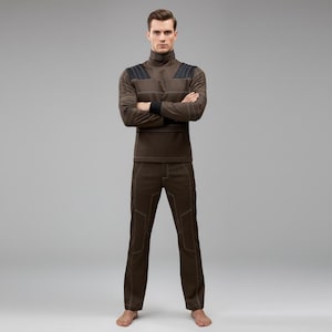 May include: A brown turtleneck long-sleeve shirt and matching pants. The shirt has black accents on the shoulders and cuffs, with visible stitching. The pants have a similar design with visible stitching. The outfit is a solid color and appears to be made of a comfortable material.