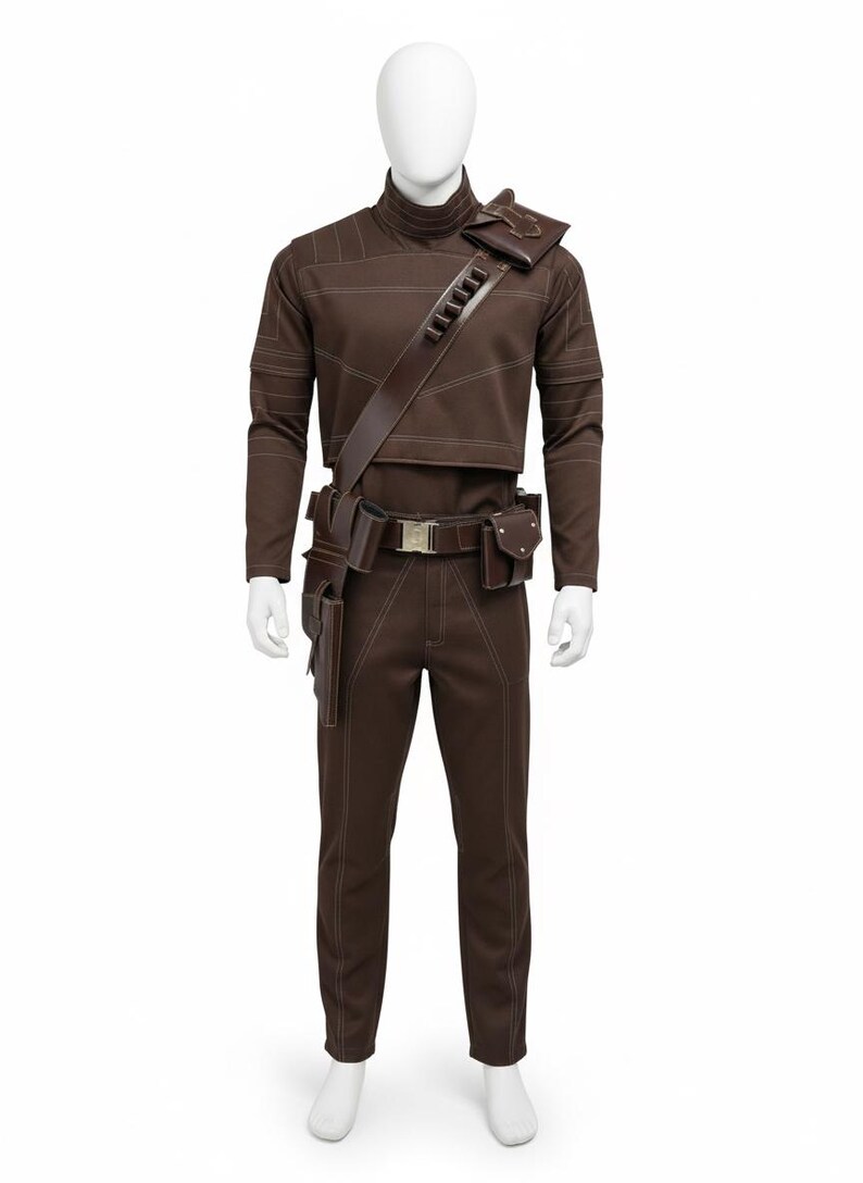 May include: Brown costume with white stitching, featuring a high-collared top, pants, and a utility belt with pouches. A shoulder strap with a rectangular pouch is also included. The outfit is displayed on a mannequin.