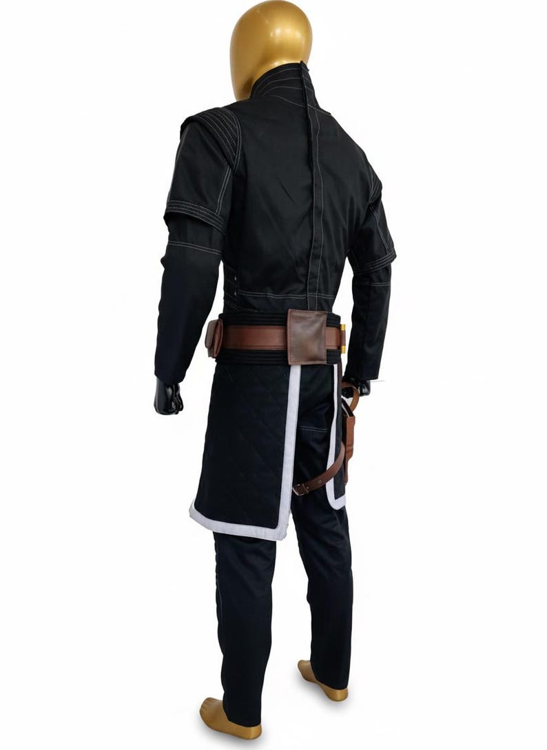 May include: Black costume with white stitching and trim, featuring a jacket, trousers, and a belt with pouches. The costume includes a quilted skirt-like piece with white trim. The mannequin has a gold head.
