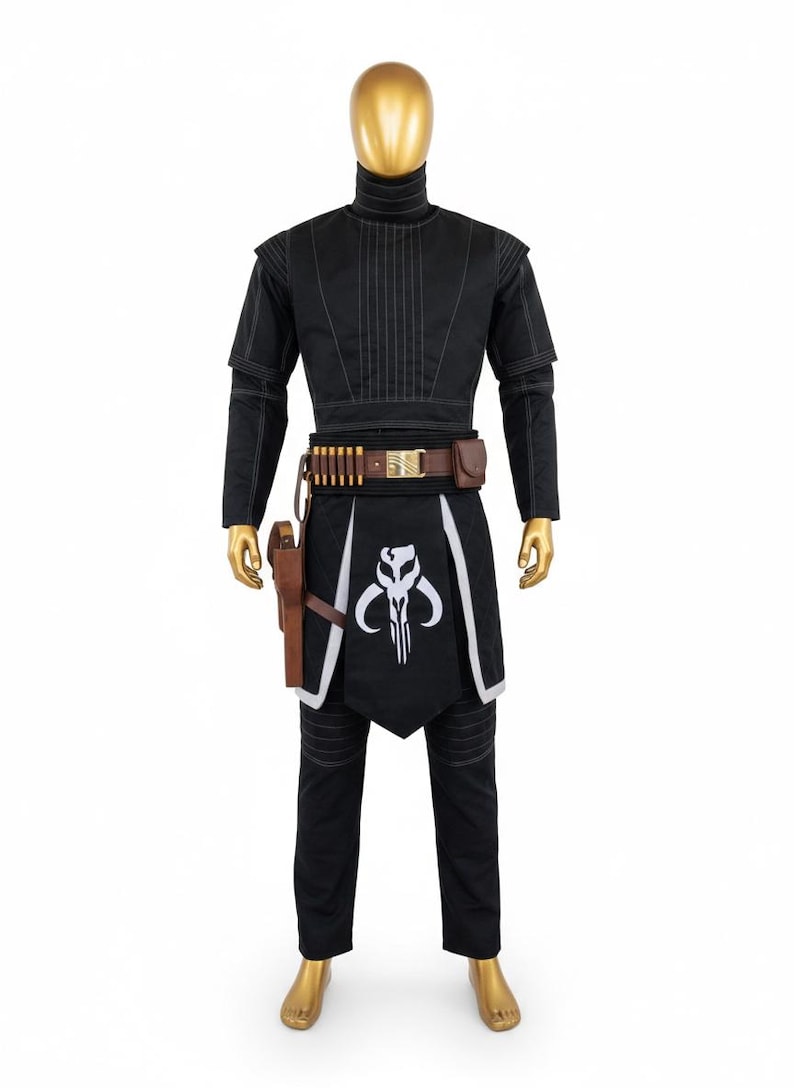 May include: Black costume with white detailing, comprising a high-necked top, trousers, and a decorative apron with a white skull emblem. Includes a brown belt with pouches and a holster. The mannequin is gold.