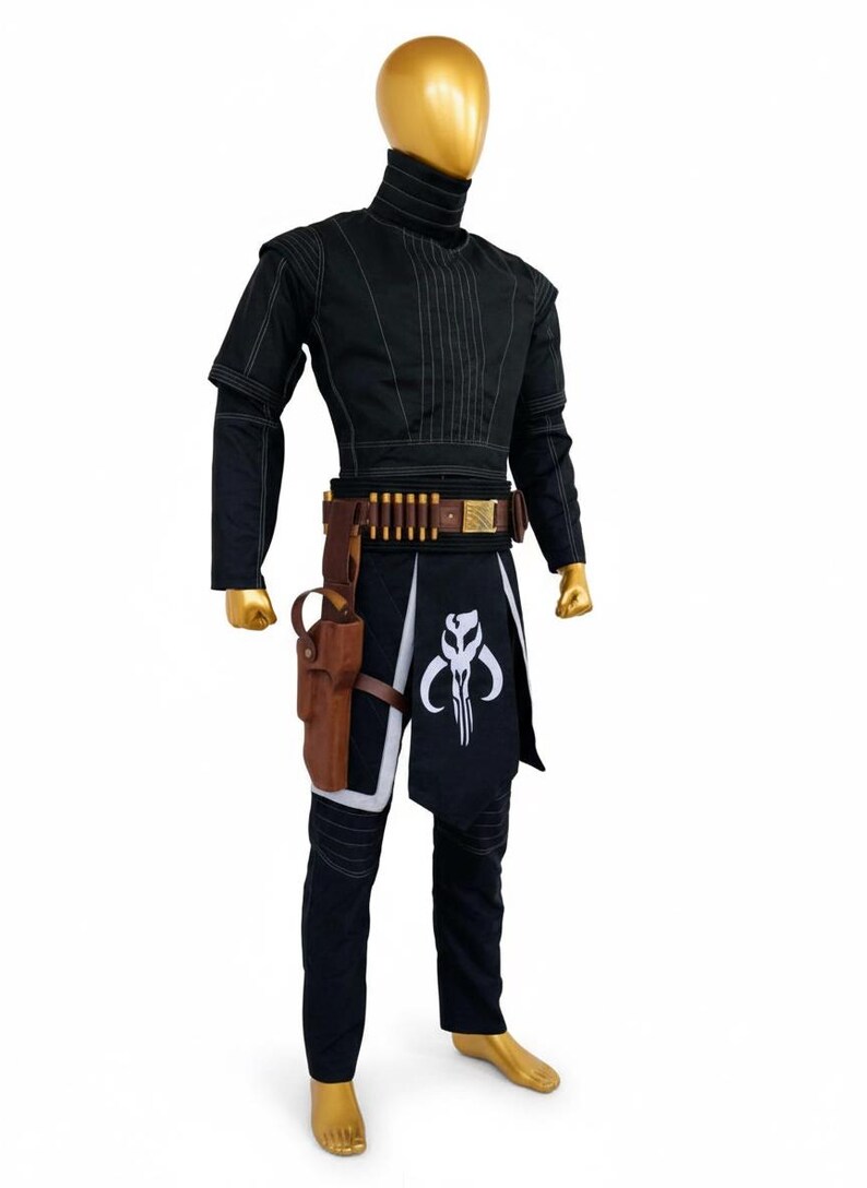 May include: A black costume with a high collar, featuring a brown belt with ammunition and a holster. The costume includes a black and white skirt with a skull emblem and black trousers. The mannequin has a gold head and feet.