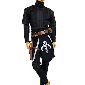 May include: Black costume with a high collar, white stitching, and a brown belt with ammunition. The costume includes a black and white apron with a skull emblem, a holster, and black trousers. The mannequin has a gold head and feet.