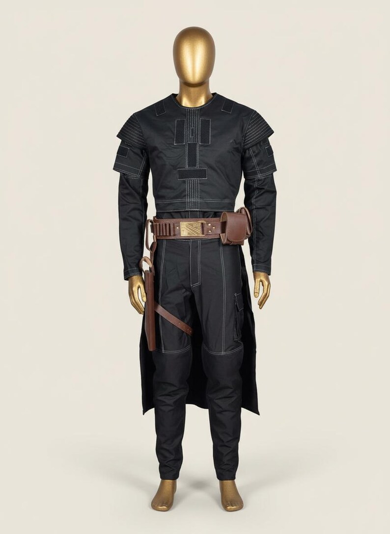 May include: Black costume with white stitching, displayed on a mannequin. The outfit includes a long-sleeved top, pants, and a long coat. A brown belt with a pouch and a holster are also included. The mannequin has a gold-colored head and hands.