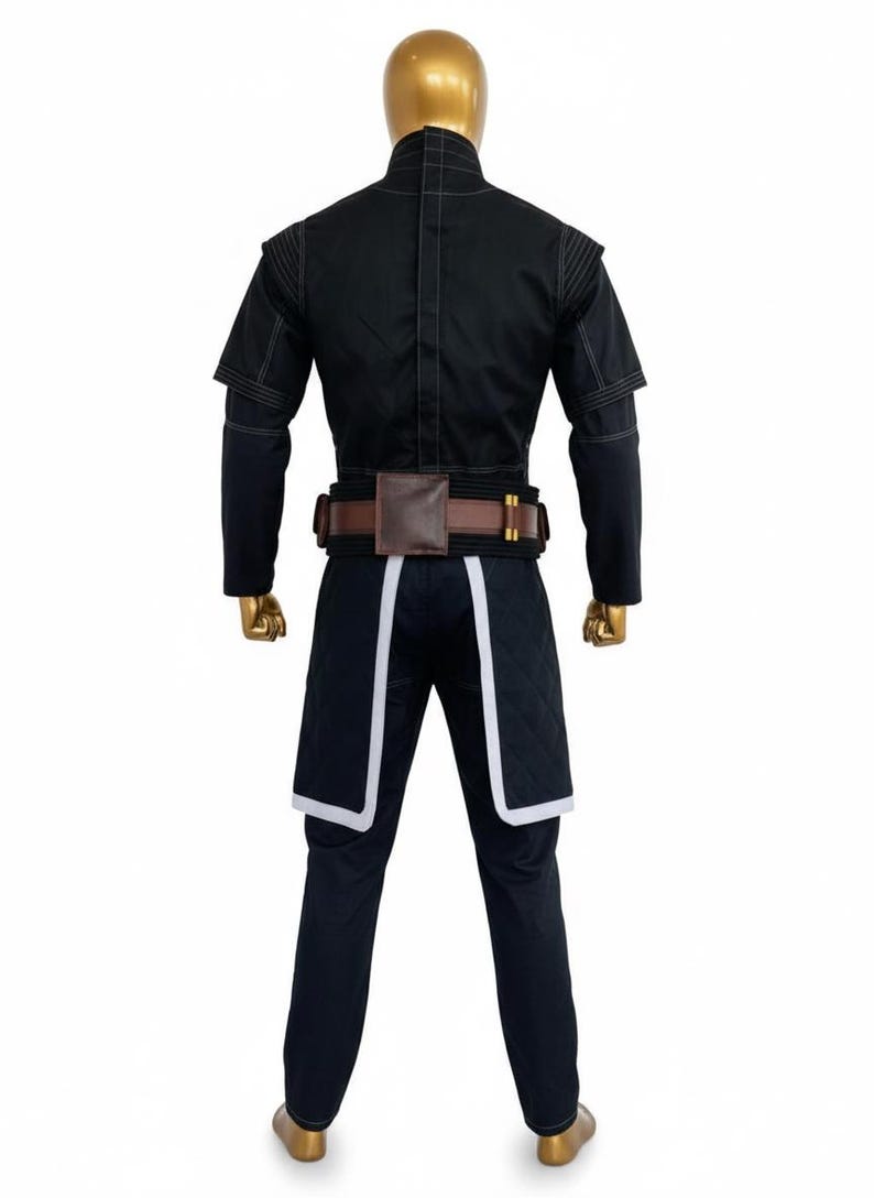 May include: Black costume with a brown belt and white trim. The outfit includes a short-sleeved jacket, long-sleeved undershirt, and trousers. The belt has a brown pouch and gold-coloured accents. The trousers have white trim.