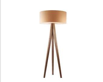 May include: A contemporary floor lamp featuring a beige drum lampshade and a dark wood tripod base. The lamp's design is minimalist, suitable for living rooms or bedrooms. The height is approximately 150 cm.