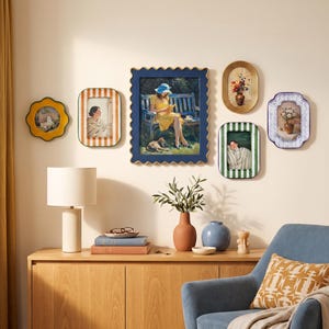 May include: A gallery wall arrangement featuring six decorative frames with varied shapes and colours, including striped and scalloped edges, surrounding a central rectangular painting of a person in a yellow dress sitting on a blue bench.