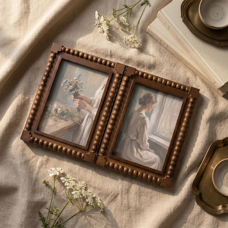 May include: A double-hinged wooden picture frame with a beaded border design. The left frame displays an illustration of hands holding a bouquet of flowers, while the right frame shows an illustration of a person in a light-colored dress near a window.