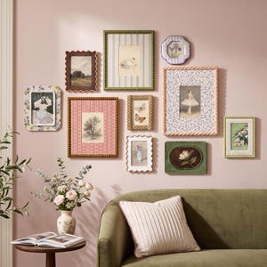 May include: A gallery wall arrangement featuring ten assorted rectangular and oval picture frames in various colors and textures, including floral, striped, and solid patterns, surrounding diverse art prints of nature and figures.