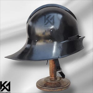 Medieval German Sallet Helmet constructed from 16G mild steel, offering full protection and authentic historical design. Ideal for SCA, LARP, Buhurt, and HMB battles, this knight helmet features polished finish, padded interior, and riveted craftsmanship. Perfect for reenactments, collectors, or cosplay enthusiasts who appreciate realistic medieval armor.