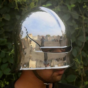 German Sallet Helmet forged from 16-gauge mild steel, combining durability with authentic medieval design. Full protection for SCA, LARP, HMB, and Buhurt combat, with riveted and polished finish. Padded interior ensures comfort for long use. Perfect for cosplay, reenactment, and collectors of realistic knight armor.