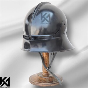 16G Mild Steel German Sallet Helmet handcrafted for historical accuracy and durability. Full head protection with padded interior, riveted construction, and polished finish. Ideal for medieval reenactments, SCA, LARP, HMB, and Buhurt events. Also suitable as a collectible or display piece for enthusiasts of medieval knight armor.