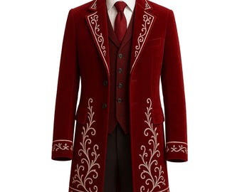 May include: A burgundy velvet coat with ornate cream-colored embroidery. The coat features a matching vest and tie, creating a formal ensemble. The design includes a long coat with a tailored fit, perfect for special occasions.