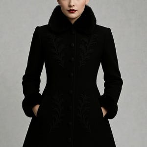 May include: A long black coat with a faux fur collar and cuffs. The coat features intricate embroidered floral designs on the front and sleeves. It has a button-down closure and pockets.