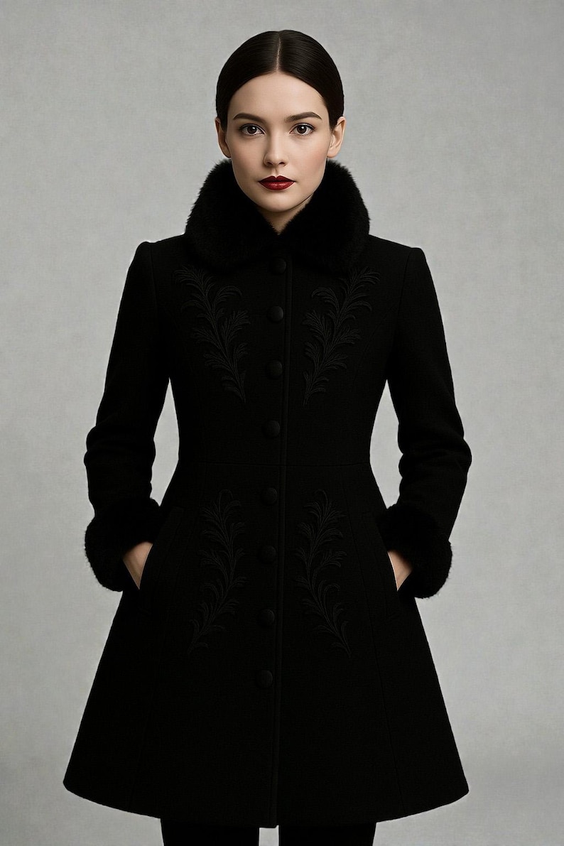 May include: A long black coat with a faux fur collar and cuffs. The coat features intricate embroidered floral designs on the front and sleeves. It has a button-down closure and pockets.