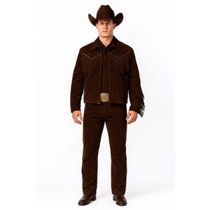 May include: A brown suede cowboy outfit, including a jacket with fringe and a matching hat and pants. The jacket has decorative studs and the belt buckle is gold. The outfit is a classic Western style.