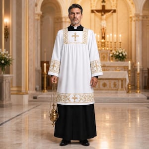 May include: A white liturgical vestment with gold embroidery, featuring a cross design on the chest and sleeves. The vestment is worn over a black cassock. The person is holding a gold censer in a church setting.