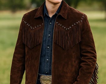 May include: A brown suede jacket with fringe detailing and a black cowboy hat. The jacket has decorative stitching and is paired with a denim shirt and blue jeans. A gold belt buckle adds a touch of flair.