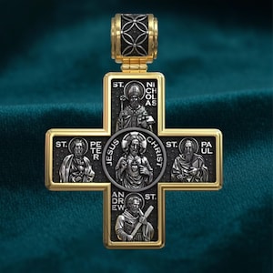 May include: A gold-toned cross pendant with detailed religious figures and text. The cross features images of saints and the words "JESUS CHRIST." The pendant has a decorative bail and a dark teal background.