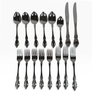 May include: A set of fifteen pieces of silver-toned stainless steel flatware, including eight forks, five spoons, one smaller teaspoon, and two dinner knives. Each piece features a decorative embossed floral pattern on the handle.