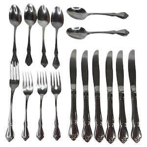 May include: A set of stainless steel flatware consisting of four spoons, three forks, two additional spoons, and six knives. Each piece features a polished silver finish and a decorative floral motif embossed on the handle base.