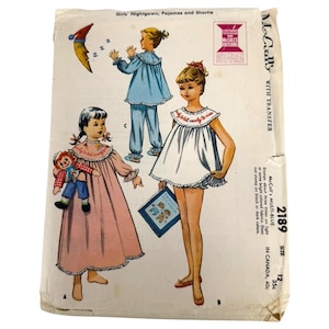 May include: Vintage McCall's sewing pattern for girls' nightgowns, pajamas, and shorties. The pattern features illustrations of children in various sleepwear styles. The package includes the McCall's Multi-Blue transfer and size 12.
