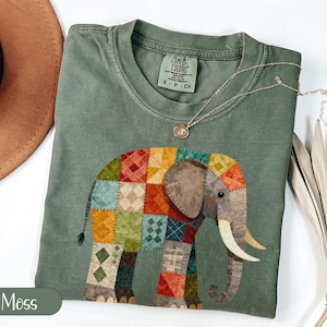 May include: A white ceramic mug with a black handle and the text "But First, Coffee" in a bold, black font. The mug is set against a blurred background, suggesting a cozy setting.