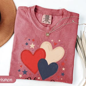 Red, white, and blue heart graphic t-shirt with stars and "Crismon".
