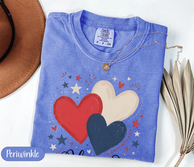 Blue t-shirt with red, white, and dark blue heart graphic and patriotic stars.