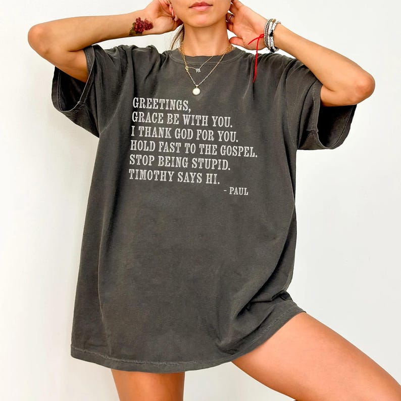 Charcoal t-shirt with white text: "Greetings, Grace be with you..."
