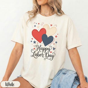 Cream t-shirt with red, white, and blue hearts and "Happy Labor Day" text.