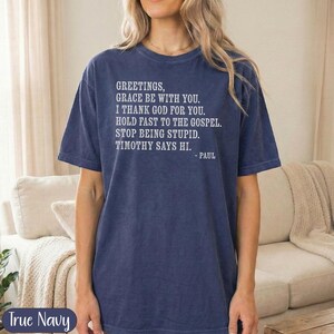 Navy t-shirt with "Greetings, Grace Be With You..." scripture from Paul.