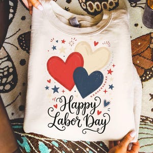 Cream sweatshirt with red, white, and blue hearts and "Happy Labor Day" text.
