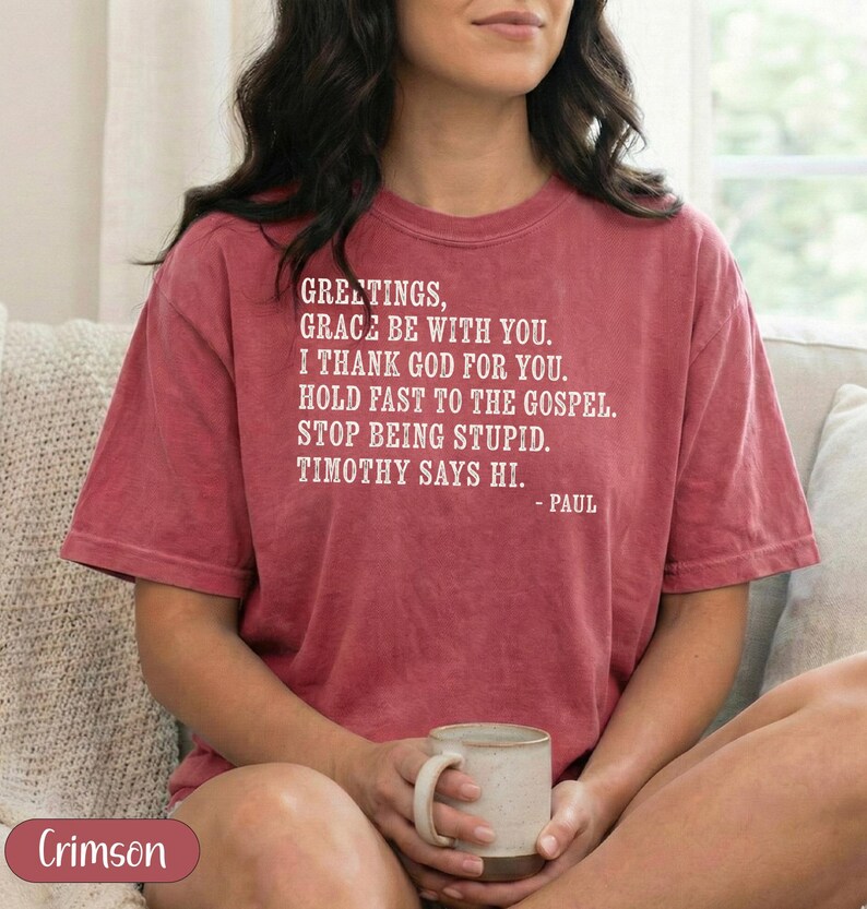 Crimson t-shirt with "Greetings, grace be with you..." text.