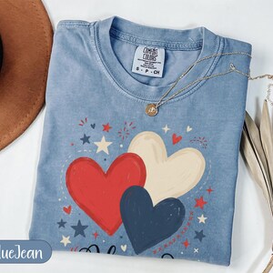 Blue t-shirt with red, white, and blue hearts graphic and "Blue Jean" text.