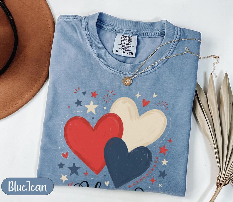 Blue t-shirt with red, white, and blue hearts graphic and "Blue Jean" text.
