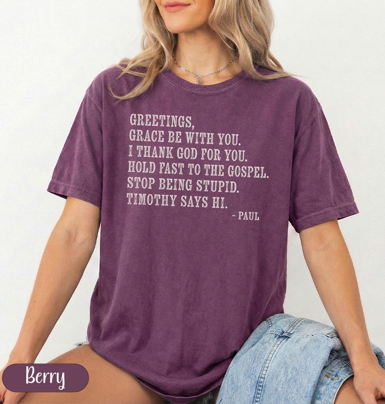 Purple t-shirt with "Greetings, Grace be with you. I thank God for you. Hold fast to the Gospel. Stop being stupid. Timothy says hi. - Paul" and "Berry" graphic.