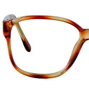 May include: Brown tortoiseshell eyeglasses with a square frame.