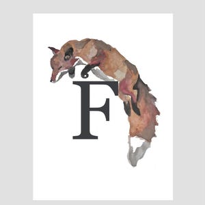 May include: Watercolor illustration of a fox in shades of brown, black, and red, positioned above a large, dark gray letter "F" on a white background. The fox appears to be leaping or falling, with its tail extended.