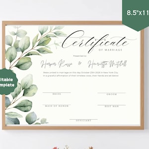 May include: A horizontal 21.6cm x 27.9cm marriage certificate template in a wooden frame, featuring watercolour eucalyptus leaves on the left. Text includes "Certificate of Marriage", "Harper Russo & Henrietta Mitchell", and signature lines.