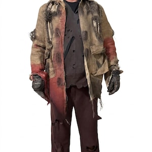 May include: A distressed tan burlap jacket with frayed edges and red patches, worn over a dark brown shirt with multiple small tears. The outfit includes dark brown trousers with holes and black gloves, creating a rugged, weathered appearance.