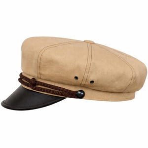 May include: A tan-coloured newsboy cap with a black peak. It has a brown rope detail around the base and a small button on top. A classic style, the cap is suitable for various outfits.
