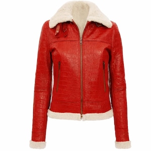 May include: A red leather jacket with a white faux fur collar and lining. The jacket has a zipper closure, two front pockets, and fur trim on the cuffs. The leather has a textured appearance.