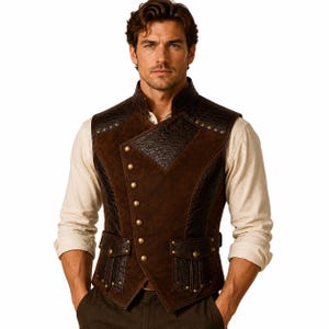 May include: A dark brown vest featuring a combination of smooth suede and textured leather panels. The garment has a high collar, an asymmetrical front closure with brass-toned buttons, and two front pockets with flaps accented by small metal studs.