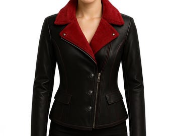 May include: A black leather jacket with a red faux fur collar and lining. The jacket features a zipper closure, button details, and red stitching accents. It has two front pockets and a tailored fit.