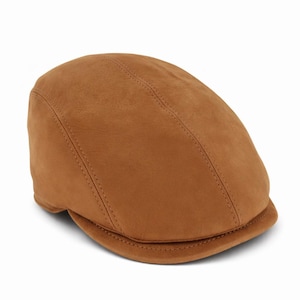 May include: A tan leather flat cap, featuring a rounded crown and a small, rigid brim. The cap has a traditional design with stitched seams and a smooth texture. The hat is a warm, earthy brown colour, suitable for various occasions.